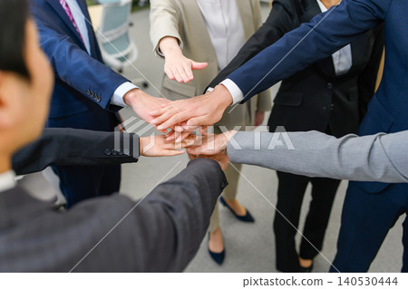 Business people joining hands in solidarity Business people joining hands in solidarity 140530444