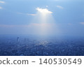 Light filtering through the clouds and the cityscape: Tokyo's streets evoke images of hope and the future. 140530549