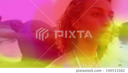 Gazing woman facing right at rocky shoreline, wearing halter strap and thin necklace, copy space Gazing woman facing right at rocky shoreline, wearing halter strap and thin necklace, copy space 140531082