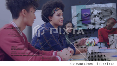 Talking woman in plaid shirt leading meeting at classroom table, with pencils, swatch and screen Talking woman in plaid shirt leading meeting at classroom table, with pencils, swatch and screen 140531348