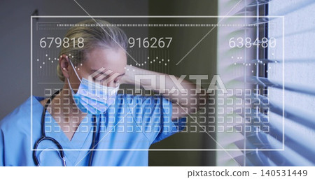 Standing female nurse blue scrubs mask rubbing neck by window blinds, stethoscope HUD, copy space Standing female nurse blue scrubs mask rubbing neck by window blinds, stethoscope HUD, copy space 140531449