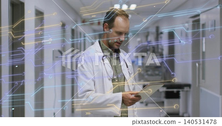 Holding tablet doctor wearing white coat reviewing data in hospital hall with stethoscope overlay Holding tablet doctor wearing white coat reviewing data in hospital hall with stethoscope overlay 140531478