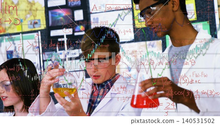 Inspecting colored beakers, four students wearing white lab coats and goggles working at school lab Inspecting colored beakers, four students wearing white lab coats and goggles working at school lab 140531502