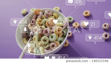 Showing white ceramic bowl holding bright cereal rings on purple tabletop, metal spoon and alerts Showing white ceramic bowl holding bright cereal rings on purple tabletop, metal spoon and alerts 140531546