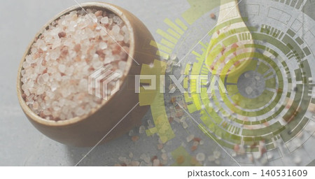 Sitting round bowl holding coarse pink salt on gray stone, green leaf and HUD, copy space 140531609