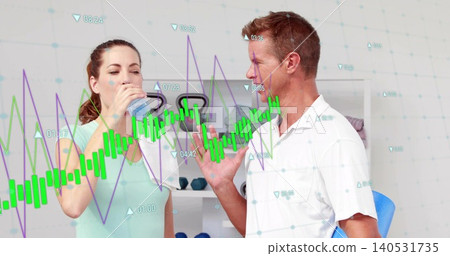 Drinking woman in mint tank listening to gesturing coach at gym with water bottle towel charts Drinking woman in mint tank listening to gesturing coach at gym with water bottle towel charts 140531735