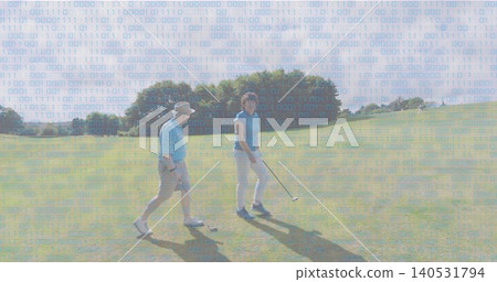 Walking senior couple wearing light-blue polos, man wearing sun hat, holding golf clubs on fairway Walking senior couple wearing light-blue polos, man wearing sun hat, holding golf clubs on fairway 140531794