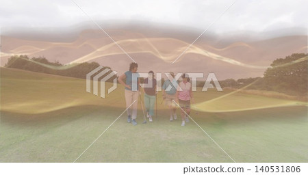 Walking four golfers holding clubs on manicured golf fairway, wearing polos and visors Walking four golfers holding clubs on manicured golf fairway, wearing polos and visors 140531806