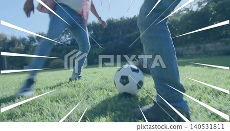 Controlling man and boy moving around soccer ball in backyard, with sneakers, jeans, motion lines Controlling man and boy moving around soccer ball in backyard, with sneakers, jeans, motion lines 140531811