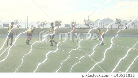 Training six players passing and dribbling on turf with sticks, ball, yellow or red bibs, wavy strea Training six players passing and dribbling on turf with sticks, ball, yellow or red bibs, wavy strea 140531838