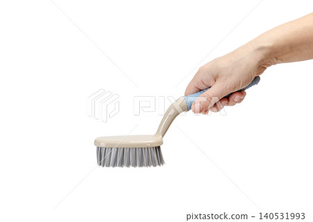 Woman holding a plastic brush on the white background. 140531993