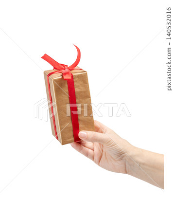 Woman's hand holding a gift box on the white background. Woman's hand holding a gift box on the white background. 140532016