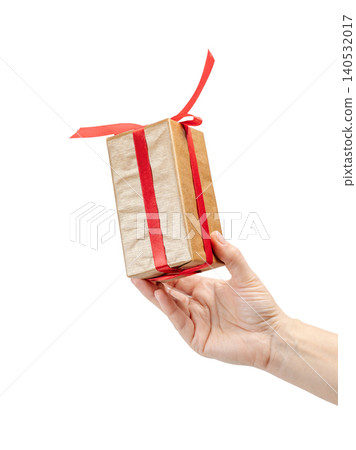 Woman's hand holding a gift box on the white background. Woman's hand holding a gift box on the white background. 140532017