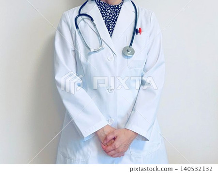 A female doctor in a white coat (front view, standing). A female doctor in a white coat (front view, standing). 140532132