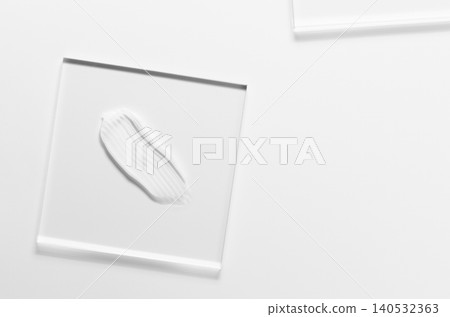 White cosmetic skin care product on glass. White background. Copy space 140532363