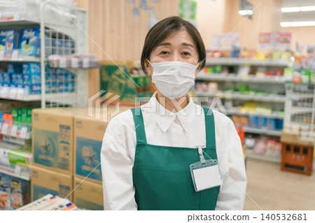 A supermarket employee wearing a mask A supermarket employee wearing a mask 140532681