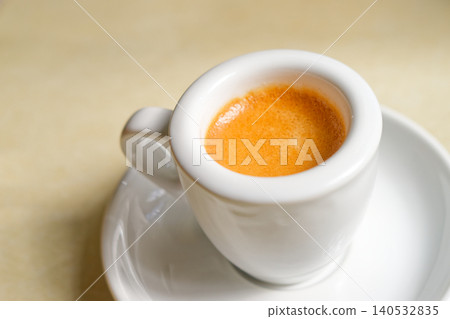 Minimalist Espresso with crema in White Coffee Cup on Saucer, Top View Minimalist Espresso with crema in White Coffee Cup on Saucer, Top View 140532835