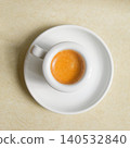 Minimalist Espresso with crema in White Coffee Cup on Saucer, Top View 140532840