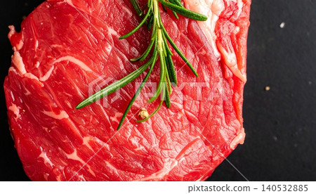 Steak with rosemary on a black background. Top view 140532885