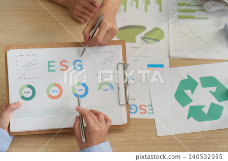Two people analyzing ESG sustainability data and recycling report Two people analyzing ESG sustainability data and recycling report 140532955