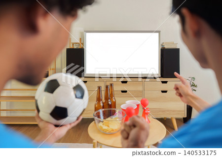 Asian and Southeast Asian men watching football game on blank TV screen Asian and Southeast Asian men watching football game on blank TV screen 140533175