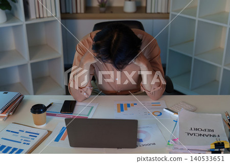 Asian man stressed by financial reports and economic slowdown at home office Asian man stressed by financial reports and economic slowdown at home office 140533651
