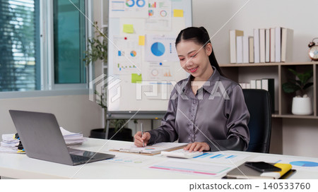 Asian woman in 20s working on finance and accounting at home office Asian woman in 20s working on finance and accounting at home office 140533760