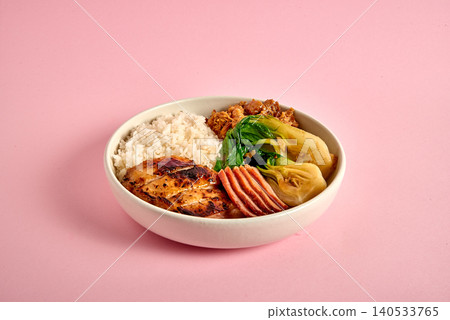 Classic roasted chicken topped with garlic on pink Classic roasted chicken topped with garlic on pink 140533765