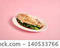 Classic roasted chicken topped with garlic on pink 140533766