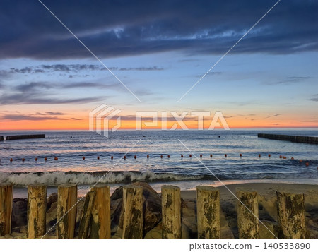 Orange sunset over calm sea with buoys Orange sunset over calm sea with buoys 140533890