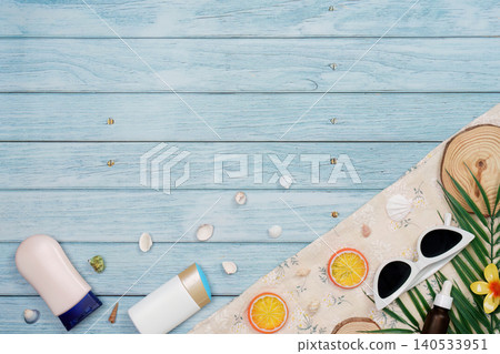 Summer beach vacation flat lay with sunscreen sunglasses and orange slices Summer beach vacation flat lay with sunscreen sunglasses and orange slices 140533951