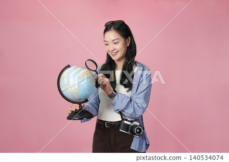 Asian woman traveler planning world exploration with globe for spring summer vacation 140534074
