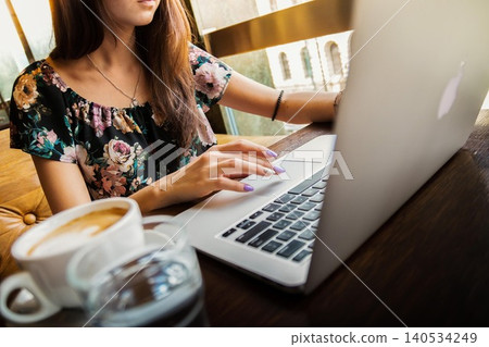 woman using laptop in cafe woman using laptop in cafe 140534249