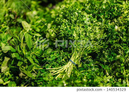 Fresh parsley and mint herbs at local market stall, organic green ingredients and healthy natural food closeup 140534329