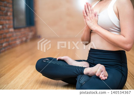 close up of woman making yoga exercises in fitness studio close up of woman making yoga exercises in fitness studio 140534367