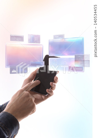 Hand holding smartphone with holographic data screens and digital dashboard on light background. Hand holding smartphone with holographic data screens and digital dashboard on light background. 140534455