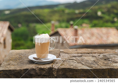 Latte coffee with scenic mountain village and countryside view Latte coffee with scenic mountain village and countryside view 140534565