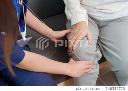 Nurse assisting a patient with knee pain Nurse assisting a patient with knee pain 140534723