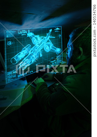 Engineer using laptop viewing military aircraft blueprint hologram in dark workspace Engineer using laptop viewing military aircraft blueprint hologram in dark workspace 140534766