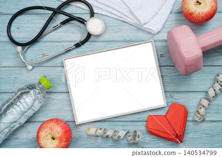 Heart health and fitness concept with stethoscope and exercise equipment Heart health and fitness concept with stethoscope and exercise equipment 140534799