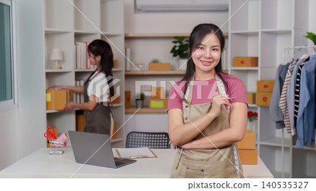 Confident Asian woman small business owner in home ecommerce office 140535327