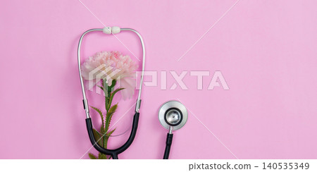 Stethoscope with pink carnation flower on vibrant background, women health Stethoscope with pink carnation flower on vibrant background, women health 140535349
