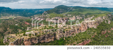 Close aerial view of Siurana village perched on towering sandstone cliffs in Catalonia, Spain. Close aerial view of Siurana village perched on towering sandstone cliffs in Catalonia, Spain. 140535650