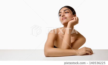 Elegant woman leaning on hand with copy space in minimalist beauty portrait. Elegant woman leaning on hand with copy space in minimalist beauty portrait. 140536225