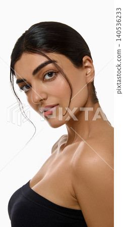 Confident woman with sleek hair strand and dewy skin in beauty portrait. Confident woman with sleek hair strand and dewy skin in beauty portrait. 140536233