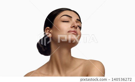 Elegant woman lifting chin with smooth neck and glowing skin on white background. Elegant woman lifting chin with smooth neck and glowing skin on white background. 140536272