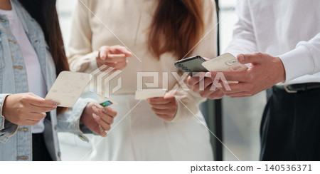 Cropped hands holding mobile app wireframe cards and smartphone for UX design prototyping 140536371