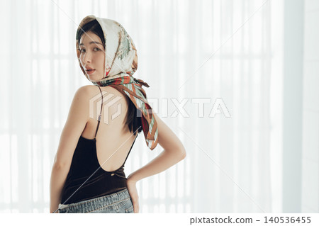 A young woman with a scarf wrapped around her head A young woman with a scarf wrapped around her head 140536455