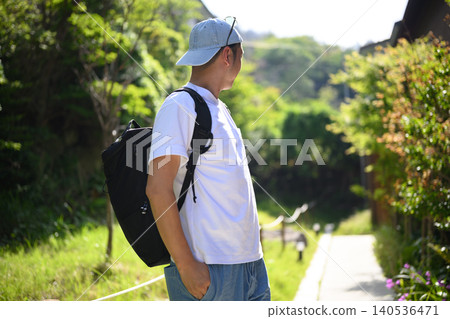 A man walking along a greenway A man walking along a greenway 140536471