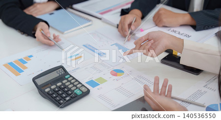 Asian business team collaborating on financial planning and budgeting with reports and calculator analysis Asian business team collaborating on financial planning and budgeting with reports and calculator analysis 140536550